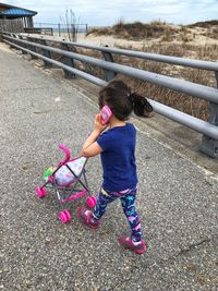 Girl standing on floor against sky