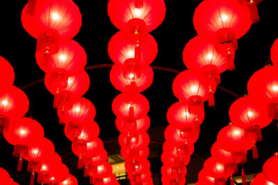 Close-up of red lantern hanging against black background