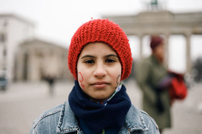 Portrait girl with female symbol painted on her face