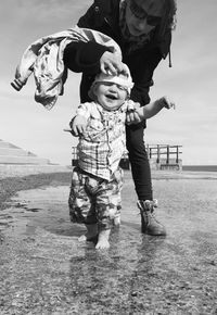  woman and baby boy on beach