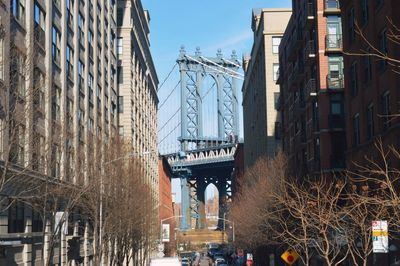 Bridge in city against sky