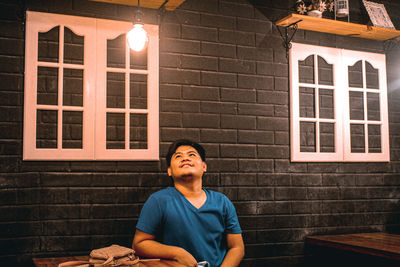 Portrait of young man sitting at home