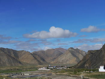 Countryside landscape against mountain range