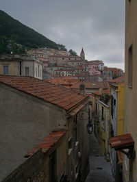 High angle view of old buildings in town against sky