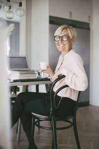 Portrait of smiling woman working at home