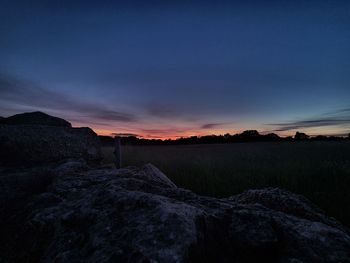 Scenic view of land against sky during sunset