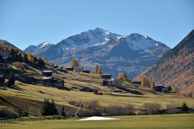 Scenic view of landscape and mountains against clear sky