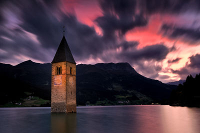 Scenic view of lake against sky at sunset