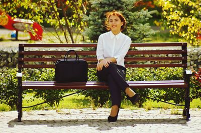 Portrait of woman sitting on bench