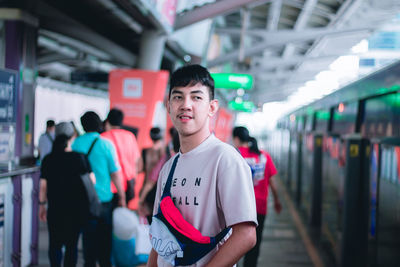 Friends standing on illuminated railroad station