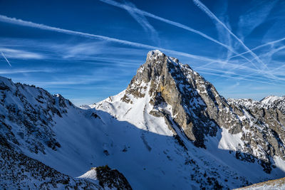 Scenic view of snowcapped mountains against blue sky