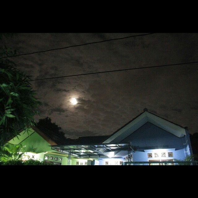 low angle view, architecture, built structure, sky, building exterior, illuminated, lighting equipment, cloud - sky, building, street light, electricity, power line, window, night, tree, house, silhouette, no people, dusk, ceiling