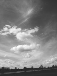 Scenic view of field against cloudy sky