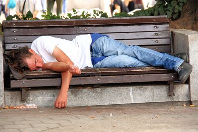 Man sitting on footpath