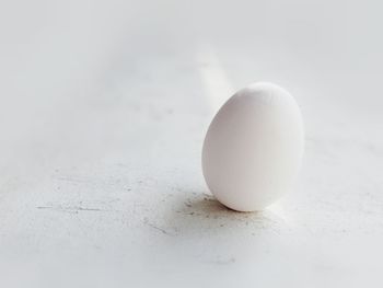 Close-up of apple on white table