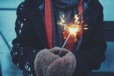 Close-up of hand holding illuminated during winter