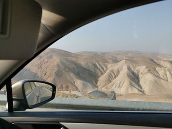 Scenic view of mountains seen through car window