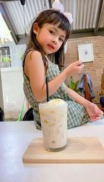 Girl holding ice cream at home