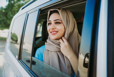 Portrait of a smiling young woman in car