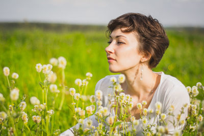 Portrait of young woman looking at camera on field