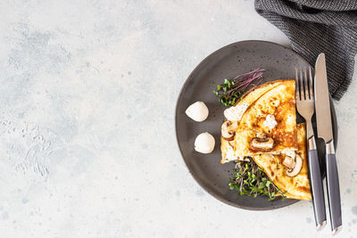 Omelette stuffed with mushroom, mozzarella cheese and microgreens for breakfast. home kitchen.