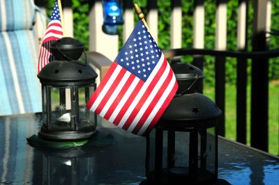 Close-up of american flags and lanterns on table