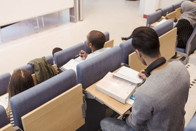 High angle view of student studying in lecture hall at university