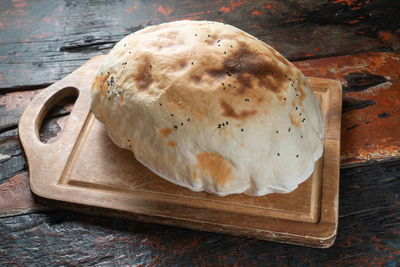 High angle view of bread on cutting board