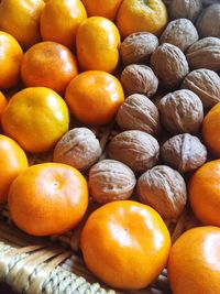 Full frame shot of tangerines and walnuts