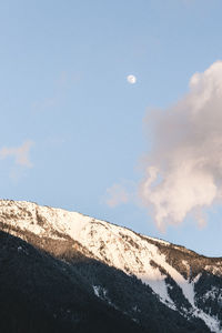 Low angle view of snowcapped mountain against sky