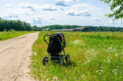 A baby carriage by a rural road in summer, estonia