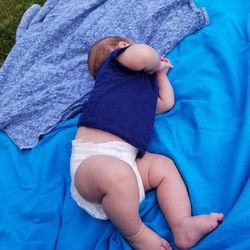 High angle view of girl sleeping on bed