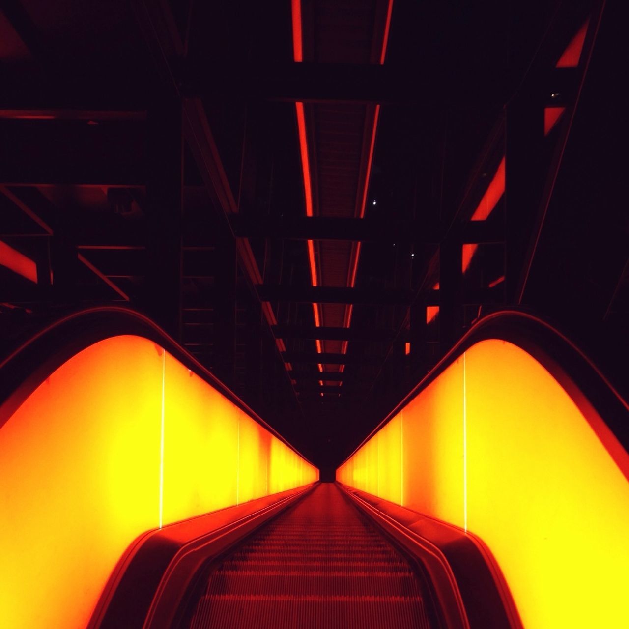 indoors, illuminated, low angle view, lighting equipment, ceiling, architecture, built structure, arch, diminishing perspective, pattern, in a row, the way forward, no people, repetition, electric light, design, railing, light - natural phenomenon, interior, steps and staircases