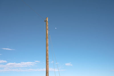 Low angle view of pole against blue sky