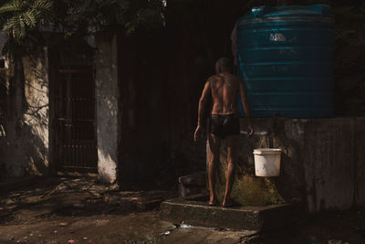 Rear view of man standing outside building