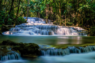 Tropical deep rainforest waterfall fresh turquoise waterfalls in deep forest in the national park 