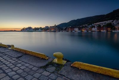 Scenic view of sea by town against sky