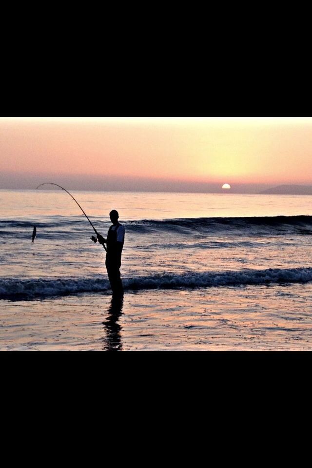 sea, horizon over water, beach, full length, sunset, water, shore, lifestyles, leisure activity, silhouette, standing, orange color, childhood, sky, wave, beauty in nature, sand, scenics