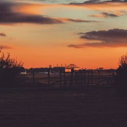 Silhouette of built structure against sunset sky