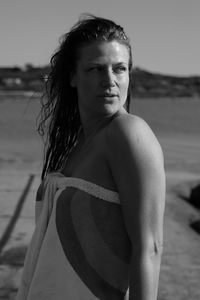 Portrait of young woman standing on beach