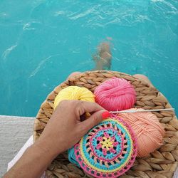 High angle view of woman knitting by swimming pool 