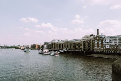 Nautical vessel on river against sky in city