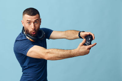 Young man exercising against clear sky