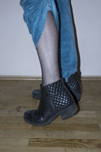 Low section of woman standing on hardwood floor