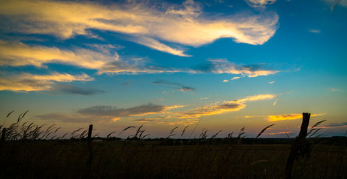 Silhouette landscape against scenic sky