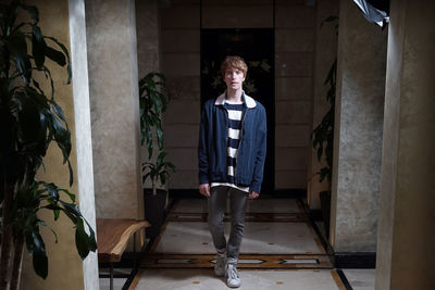 Full length of young man standing at home