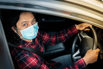 Portrait of woman sitting in car