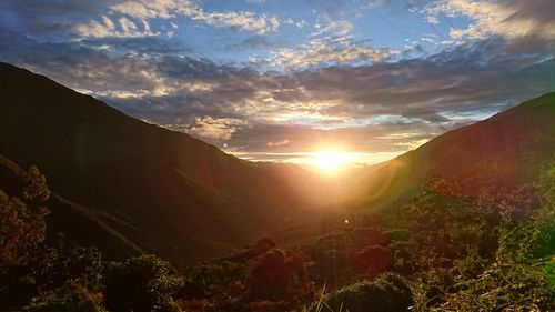 Scenic view of mountains against sky at sunset