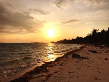 Scenic view of beach against sky during sunset