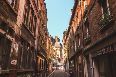 Street amidst buildings against sky in city